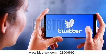 Poznan, Pol - Jul 10, 2019: Woman Holding Smartphone Displaying Logo Of Twitter, An American Online 