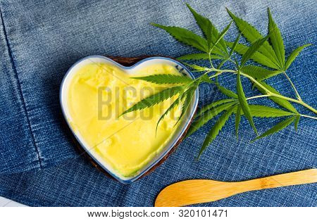 Butter With Cannabis Plant In A Heart Shape Bowl Top View