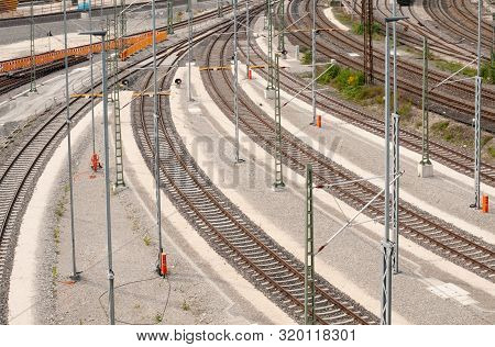View From Pedestrian Bridge Over Curved Railroad Tracks Leading To Nearby Station