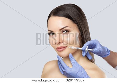 There Is A Woman, Who Is Making The Lips Augmentation Procedure  In A Beauty Salon.cosmetology Skin