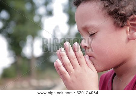 Boy Praying To God Stock Image With Hands Held Together With Closed Eyes Stock Photo