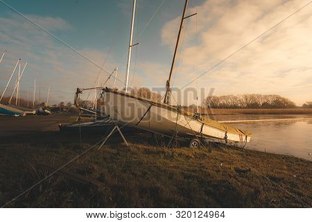 Sailing Boats On A Lake During A Frosty Winter Sunrise