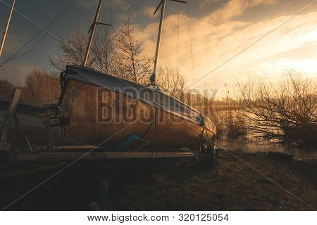 Sailing Boats On A Lake During A Frosty Winter Sunrise