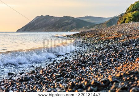 Beautiful Sunset Scenery With Wave Breaking On Stony Seashore. Scenic Landscape Of Black Sea Coast I
