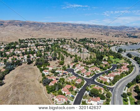 Aerial View Of Small Neighborhood With Dry Desert Mountain On The Background In Moorpark, Ventura Co