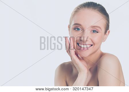 Portrait Of Beautiful Woman With Natural Make Up Touching Her Face.
