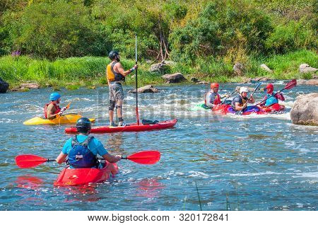 Myhiya, Ukraine - August 17, 2019: Athletes Kayakers During Training On Whitewater And Man On Inflat