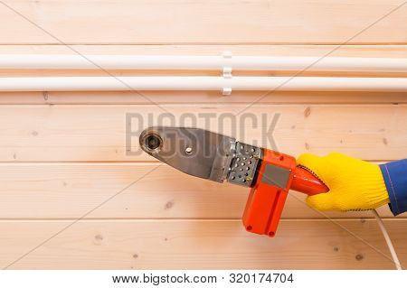 Close-up Of A Screwdriver, Tightens The Fastening Screws For Laying Polypropylene Pipes