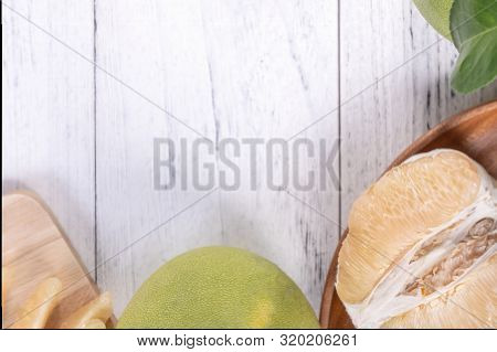 Fresh Peeled Pomelo, Grapefruit, Shaddock With Green Leaf On Bright Wooden Plank Table. Seasonal Fru