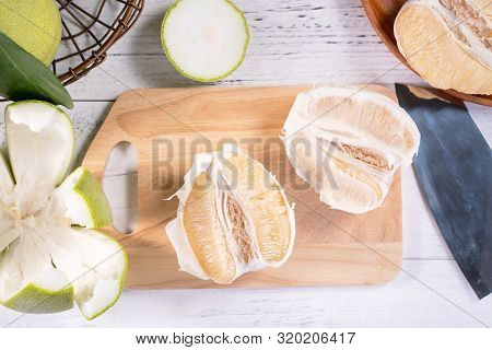 Fresh Peeled Pomelo, Grapefruit, Shaddock With Green Leaf On Bright Wooden Plank Table. Seasonal Fru