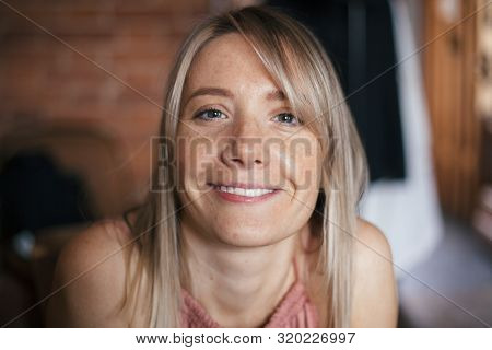Closeup Natural Warm Portrait Of A Beautiful Smiling Happy Blonde Young Woman With Sunspots. Girl Is