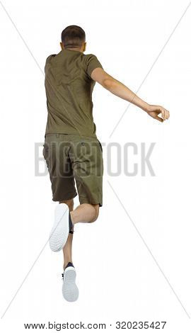 Back view of man in zero gravity or a fall. guy is flying, falling or floating in the air.  side view of person. Isolated over white background. The guy in the shorts hung in zero gravity.