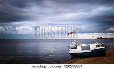 Fishing Boat On Baltic Sea Coast. Stormy Weather. Mechelinki, Poland, Pucka Bay.