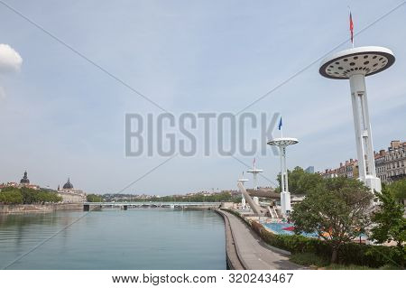 Pont De La Guillotiere Bridge In Lyon, France Over A Panorama Of The Riverbank Of The Rhone River (q