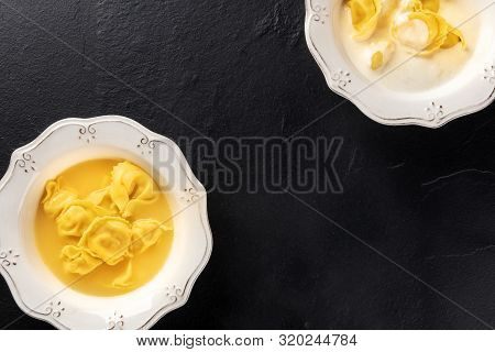 Tortellini Served With Broth And Cream Sauce, Italian Food On A Black Background With Copy Space