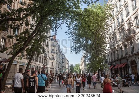 Lyon, France - July 13, 2019: Crowd Of Pedestrians Walking On Rue De La Republique Street In Lyon, F