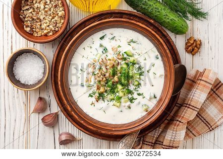 Traditional Bulgarian Cold Summer Soup Tarator With Yogurt, Dill, Cucumber And Walnuts In Ceramic Bo