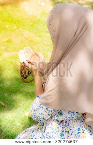 Young Adult teenager Woman making Duas for Muslim god blessing prayer.