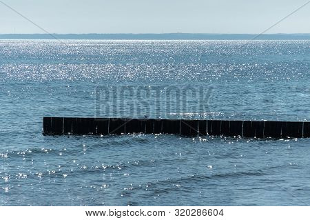 Breakwater On Beach. Wooden Sea Separator. Beautiful Seascape. Protection Holidaymakers From Effects