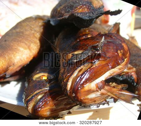 Close-up Of River Fish Smoked On Aspen Wood On A White Plate