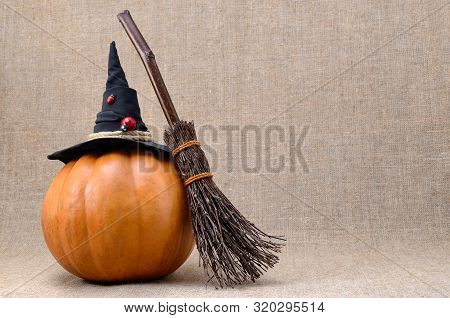 Broom And Hat Of  Witch On A Pumpkin For Halloween