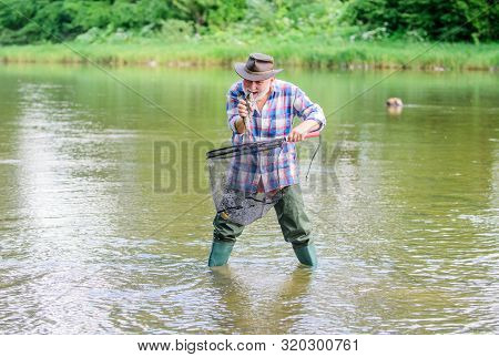Man Senior Bearded Fisherman. Pensioner Leisure. Fish Farming Pisciculture Raising Fish Commercially