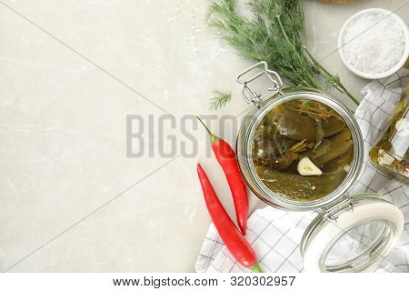 Flat Lay Composition With Jar Of Pickled Cucumbers On Light Table, Space For Text