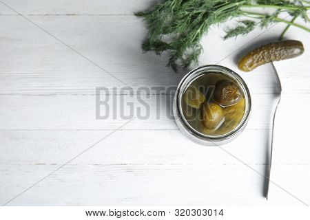 Flat Lay Composition With Pickled Cucumbers On White Wooden Table, Space For Text