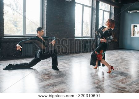 Man and woman on ballrom dance training in class
