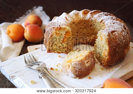 Homemade Apricot Bundt Cake And Fresh Apricots On Wooden Background