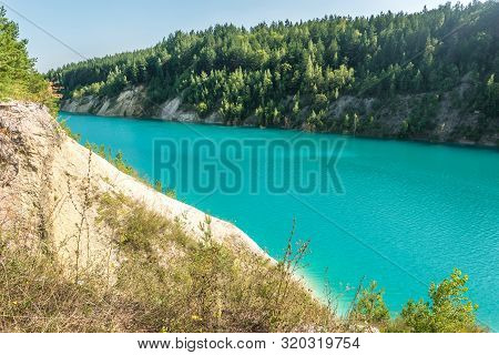 Panorama Of Chalkpit On Limestone Coast Of Huge Turquoise Lake Or River Near Forest. Chalk Quarry Fi