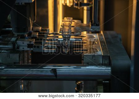 The Operation Of Pet Bottle Processing By Blowing Process With The Blowing Mould. The  Plastic Drink