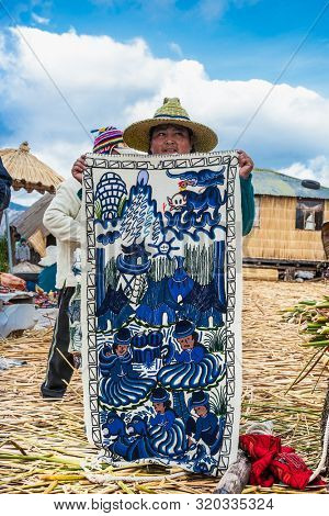 Uros, Peru- Jan 5, 2019: Inhabitants of Uros floating islands sell the rugs, Titicaca lake, Peru.