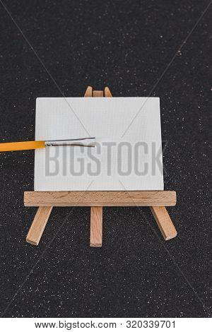 Mini Blank Canvas And Paintbrush With Copyspace