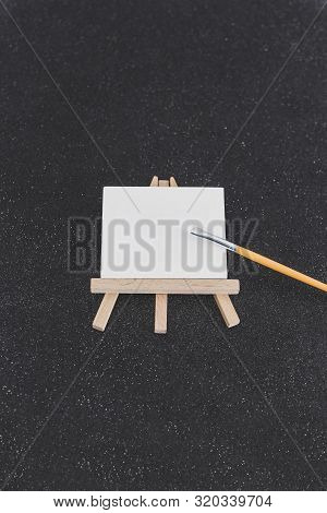 Mini Blank Canvas And Paintbrush With Copyspace