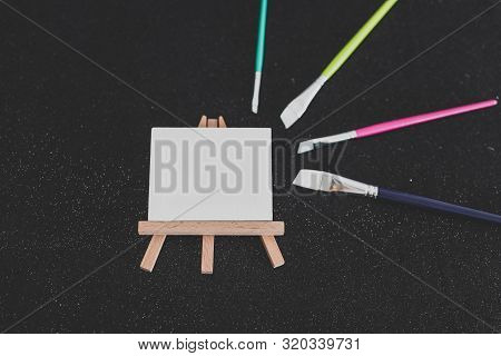 Mini Blank Canvas And Paintbrush With Copyspace
