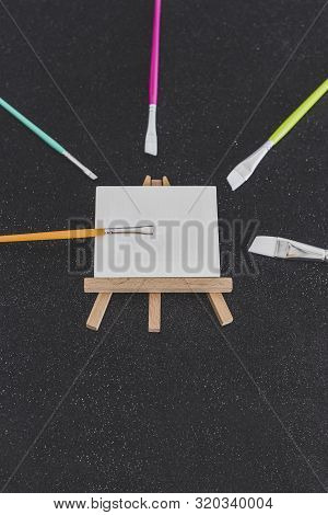 Mini Blank Canvas And Paintbrush With Copyspace