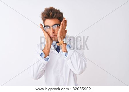 Young handsome sciencist man wearing glasses and coat over isolated white background Tired hands covering face, depression and sadness, upset and irritated for problem