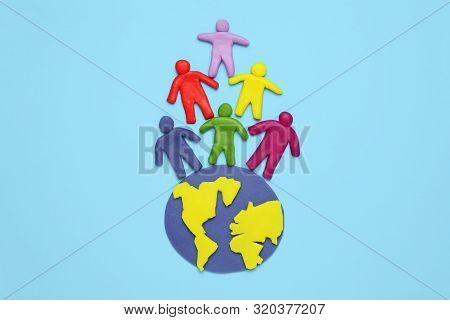Multicolored Cartoon People On Globe. The Use And Depletion Of The Planet Earth, Overpopulation And 