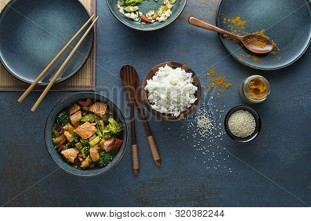 Eating Chinese Food With Rice, Salmon And Vegetables