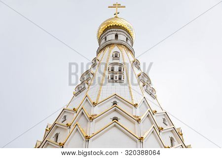 White Top Of Beautiful Christian Church With Aureate Domes Against White Sky