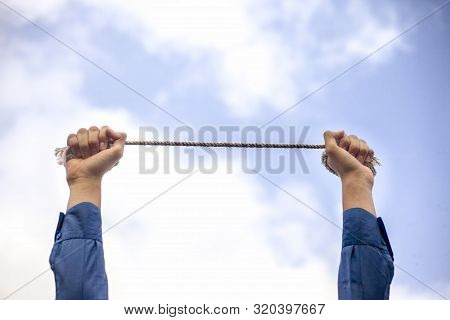 Close Upraised Hands Of A Young Businessman Wearing A Blue Colored Suit And Black Colored Necktie Wi