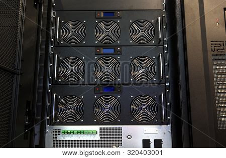 Row Of Bitcoin Miners Set Up On The Wired Shelfs. Computer For Bitcoin Mining. Cables Plug To Mother