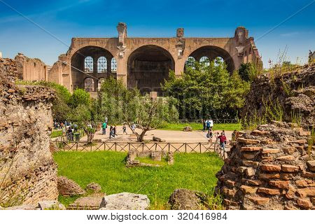 Rome, Italy - April, 2018: Tourists At The Basilica Of Maxentius And Constantine In The Roman Forum 
