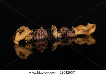 Group Of Four Pieces Of Roseship With Orange Rind Of Lingonberry Strawberry Fruit Tea Macro Isolated