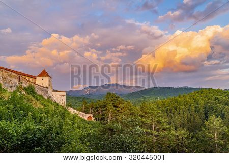 Landscape With Medieval Fortress Rasnov At Sunset, Brasov Region, Transylvania, Romania