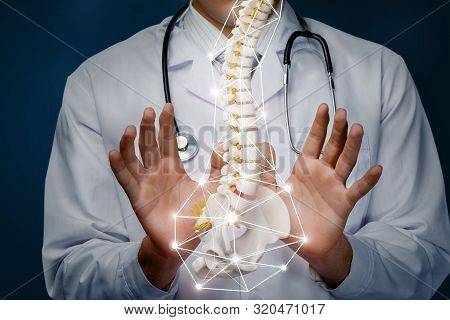 The Concept Of The Treatment Of The Spine. The Doctor Produces Manipulation With The Spine On A Blue
