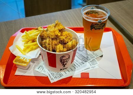 Tyumen, Russia-avg 20, 2019: Fast Food Restaurant Kfs A Bucket Of Fried Chicken A Glass Of Beer Sibe