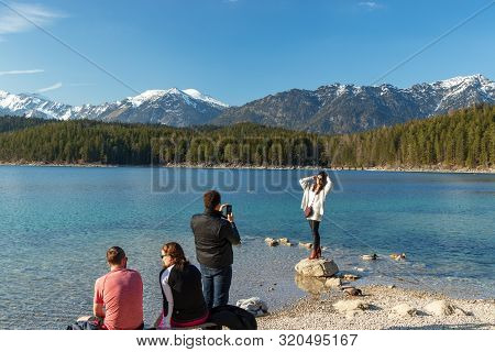 Eibsee, Germany, March 31, 2019: Husband Taking Selfie Of His Wife For Instagram At Eibsee