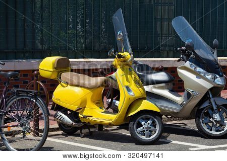 Paris, France - June 23, 2017: Italian Yellow Motor Scooter Vespa Lx125 Parked On The Street Parking